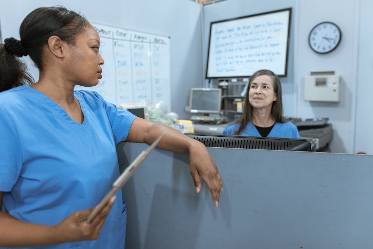 Crafting Captivating Headlines: Your awesome post title goes here Nurses in scrub suits discussing medical tasks in a clinical environment.