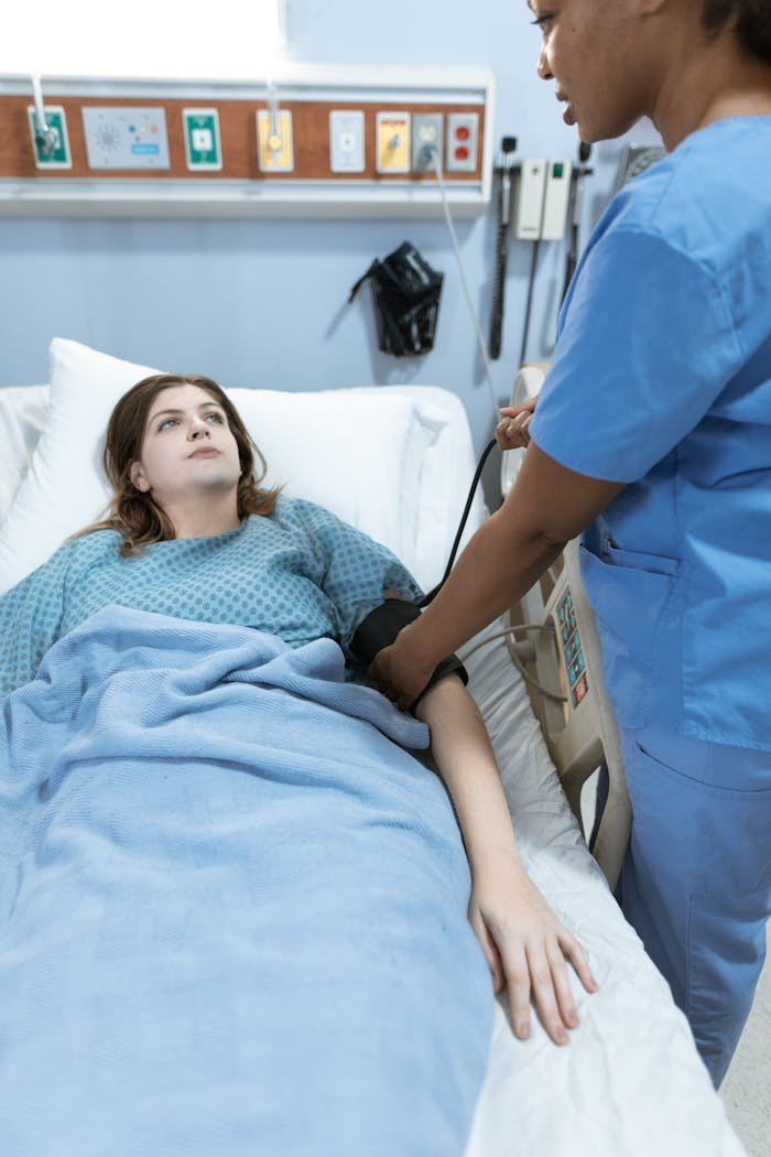 Mastering the First Impression: Your intriguing post title goes here A nurse in scrubs monitors a patients vitals in a hospital setting, providing healthcare care.
